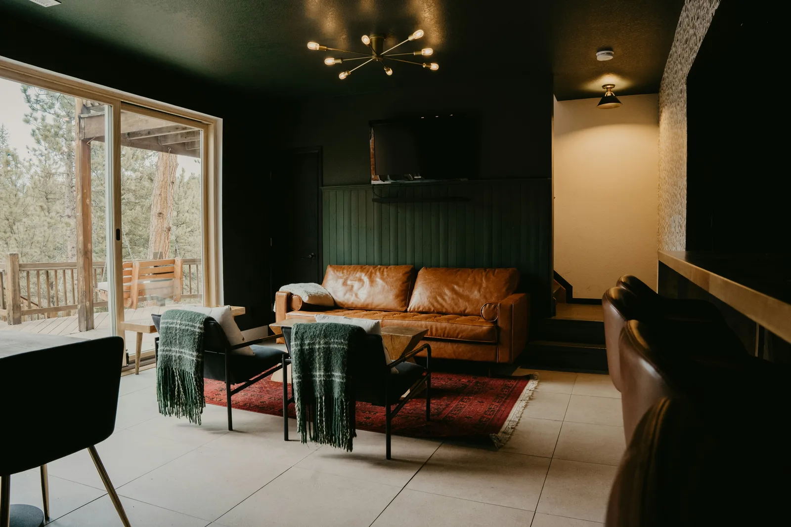 Comfortable mountain-home living room surrounded by pine trees